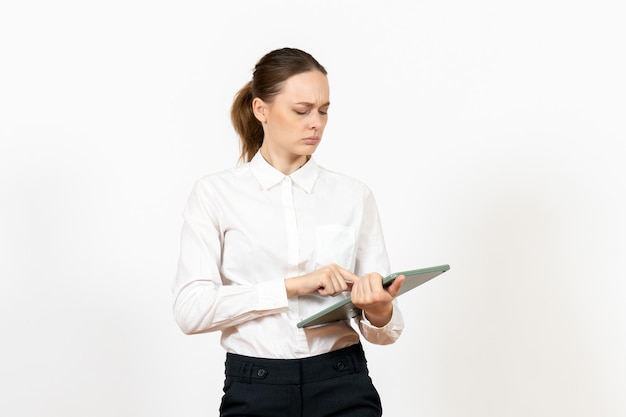 Free photo front view young woman in white blouse holding huge calculator on white desk office female emotion feeling job