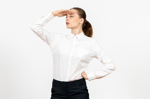 Front view young woman in white blouse looking at distance on white background office job female emotion feeling model