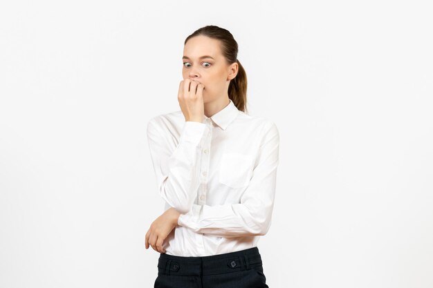 Front view young woman in white blouse with nervous face on white background office job female emotion feeling model