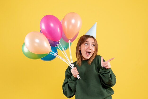 Front view young woman with colorful balloons