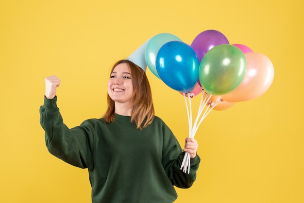 Front view young woman with colorful balloons