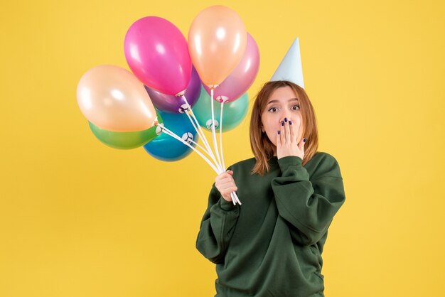 Front view young woman with colorful balloons