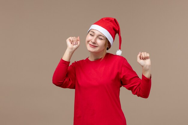 Front view of young woman with happy face on brown