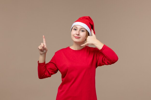 Front view of young woman with happy face on brown