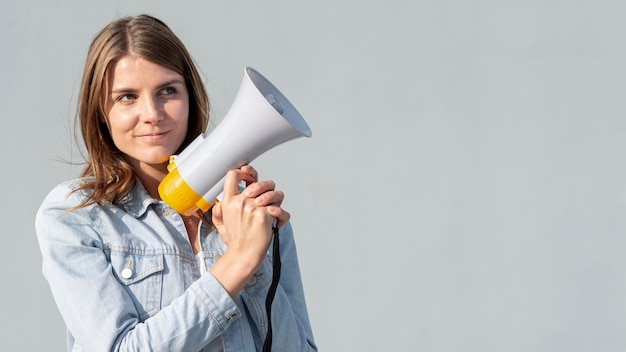 Free photo front view young woman with megaphone