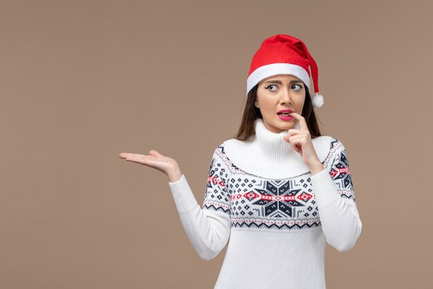 Front view young woman with nervous expression on brown background holiday emotion christmas