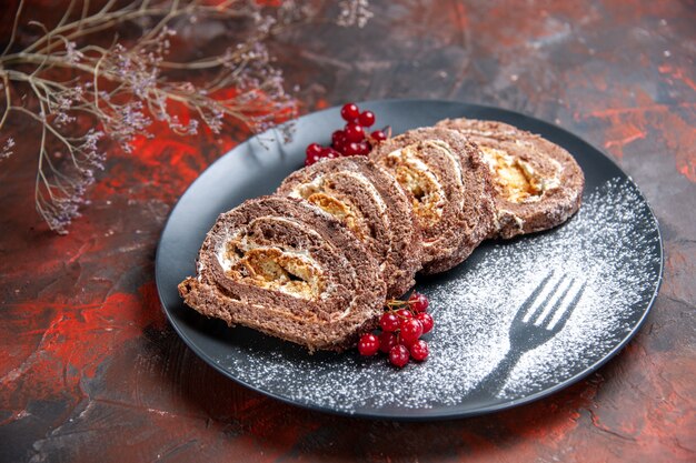 Front view of yummy biscuit rolls with fruits on dark surface