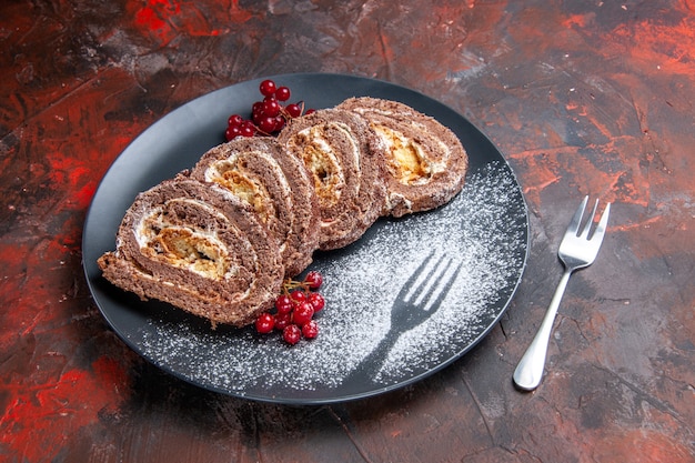 Front view of yummy biscuit rolls with fruits on dark surface