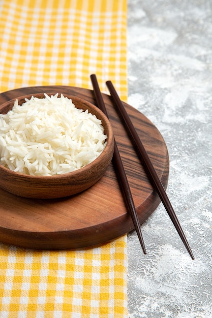 Free Photo front view yummy cooked rice inside brown plate on white desk