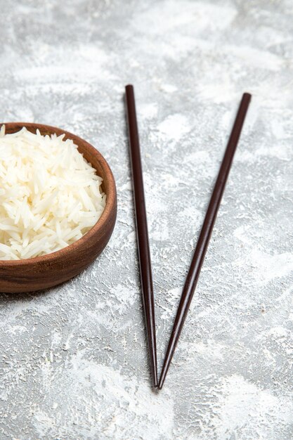 Front view yummy cooked rice inside brown plate on white floor meal rice cooking dinner dish