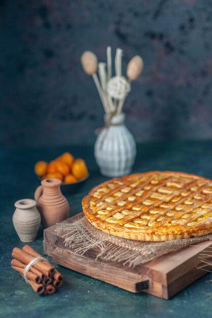 Free photo front view yummy kumquat pie on dark-blue background