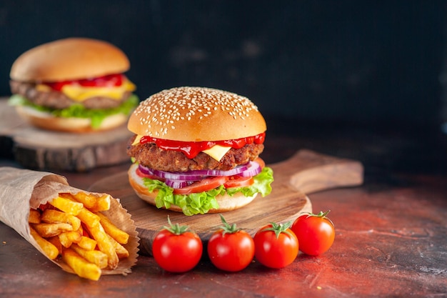 Front view yummy meat cheeseburger with french fries on dark background dinner burger fast-food sandwich toast salad dish