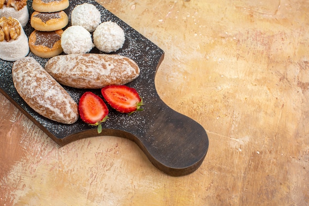 Free Photo front view yummy sweets with cookies and confitures on the wooden desk sweet cake pie