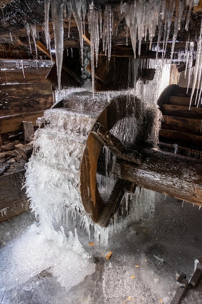 Frozen watermill in Barsana Monastery in winter Romania