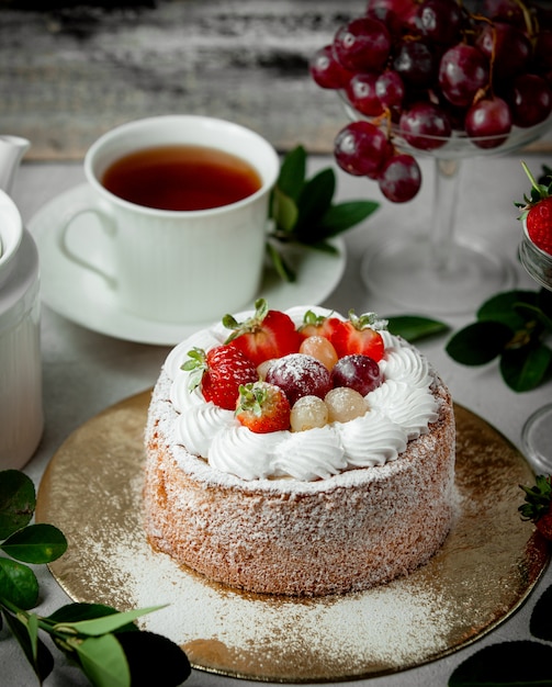 Fruit cake topped with strawberry white and red grape