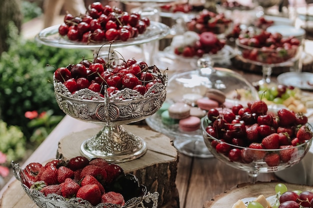 Free photo fruit cherries and strawberries and other sweets on holiday on the table decorated