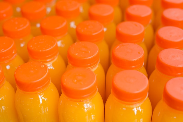 Free photo fruit juice in plastic bottle with an orange closed lid