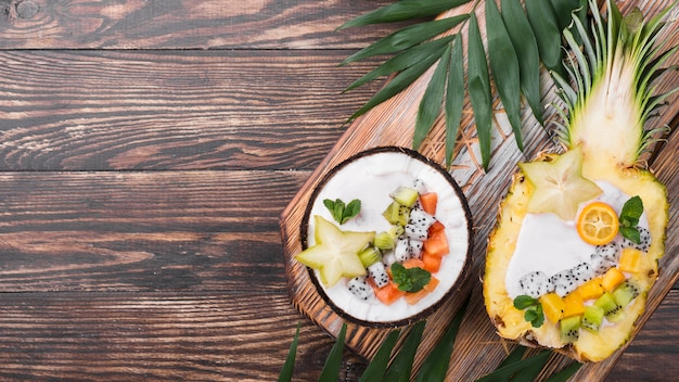 Fruit salad in coconut and pineapple plates