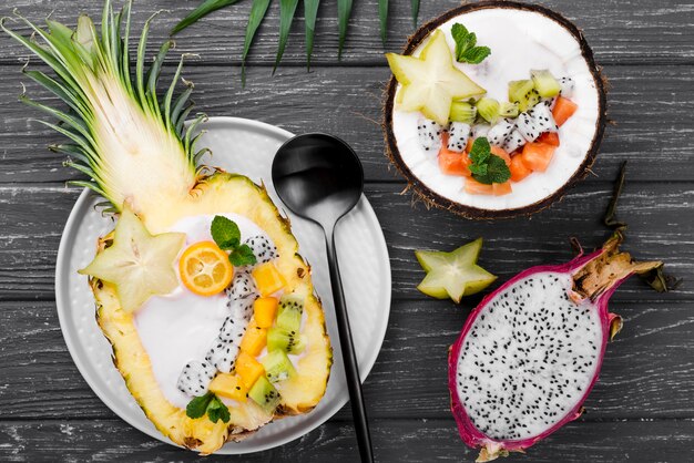 Fruit salad in coconut plate top view