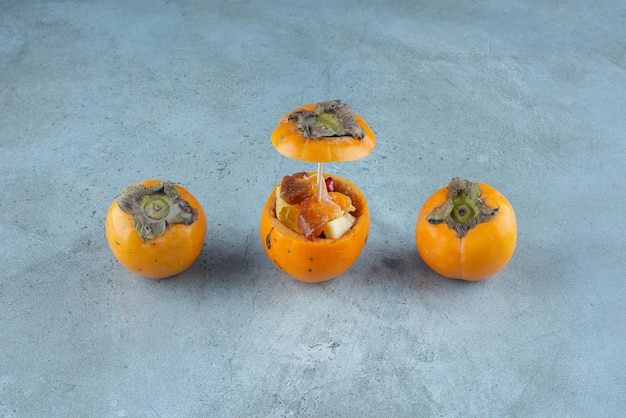 Free photo fruit salad inside a carved yellow date plums.