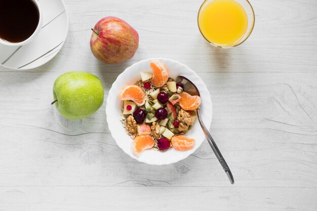 Fruit salad near apples and juice