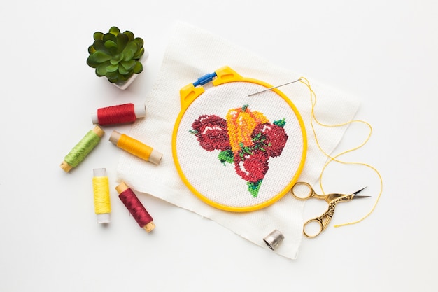 Free photo fruit sewed design with sewing threads and plant