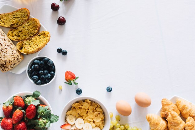 Fruits; baked bread and croissant on white background