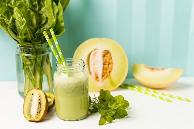 Free Photo fruits near herbs and glass with cocktail