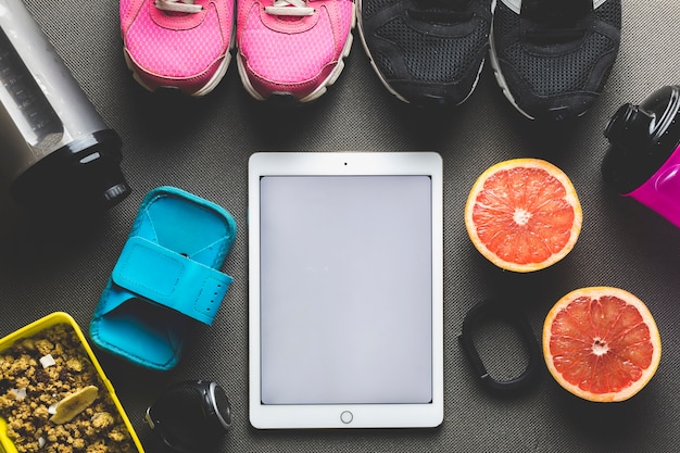 Free photo fruits and sports equipment near tablet