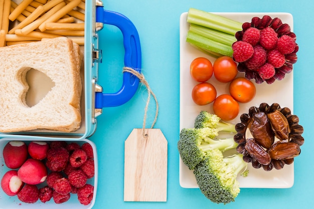 Fruits and vegetables near nice lunchbox