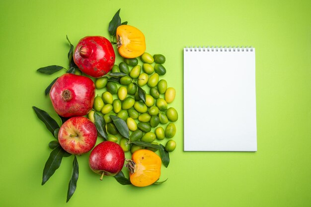 fruits white notebook pomegranates apples citrus fruits persimmons