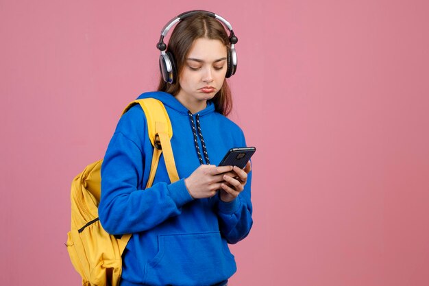 Frustrated female in headphones listening to music while surfing internet