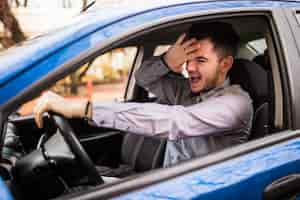 Free photo frustrated man driving car