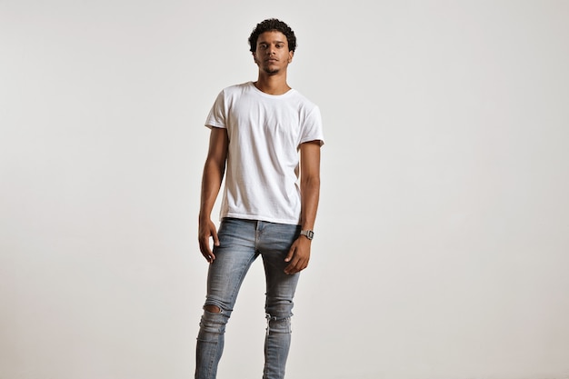 Free photo full-body portrait of an athletic young male in ripped light blue jeans and blank white shortsleeve t-shirt