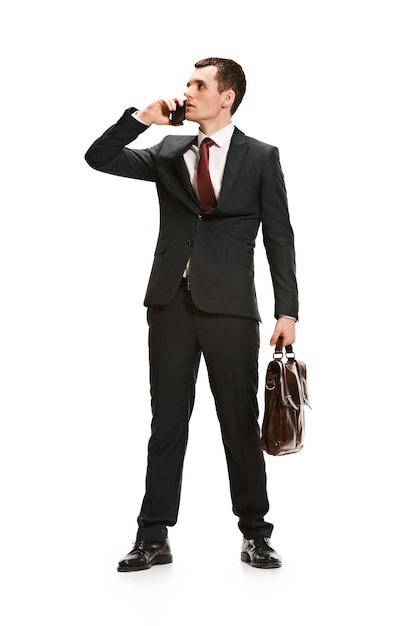 Full body portrait of businessman with briefcase on white