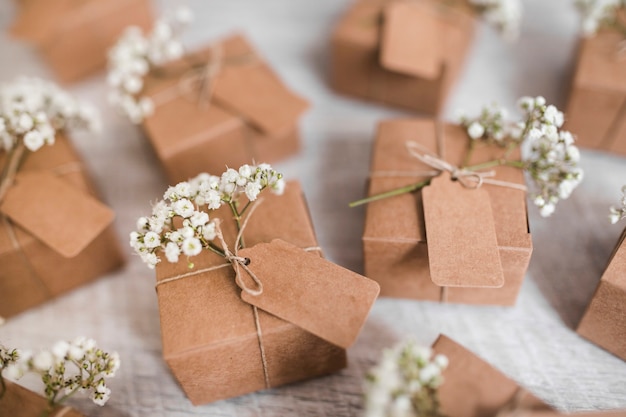 Free Photo full frame of cardboard boxes with tag and baby's-breath flowers on wooden backdrop