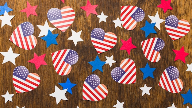 Free photo full frame of heart shape american flags and stars on wooden desk