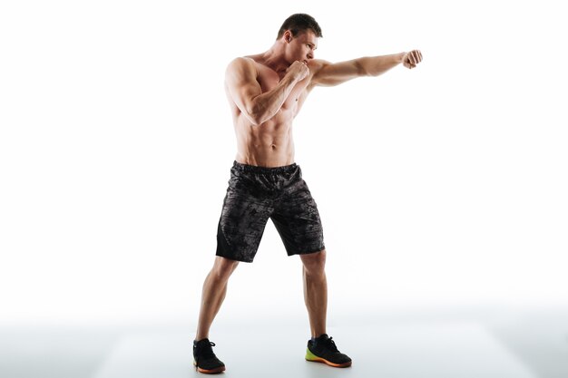 Full length photo of strong half naked man in boxing pose