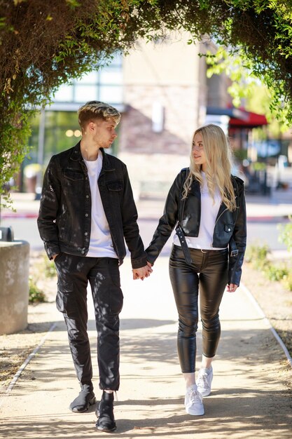 Full length photo of young couple walking at the park