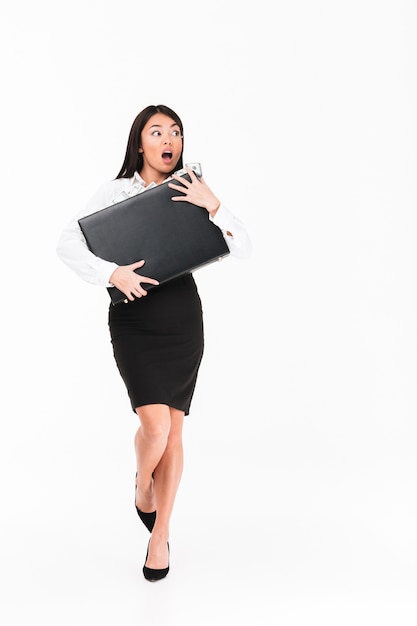 Full length portrait of an astonished asian businesswoman