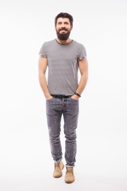 Full length portrait of Bearded man in shirt with arm in pocket which pointing away.