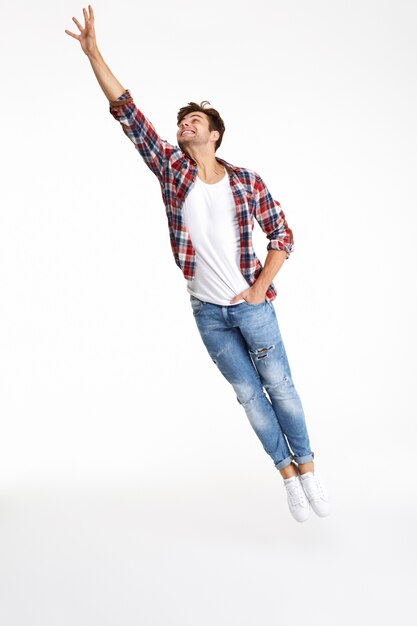 Full length portrait of a casual attractive man jumping