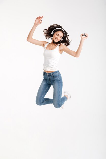 Full length portrait of a cheerful woman dressed in tank-top