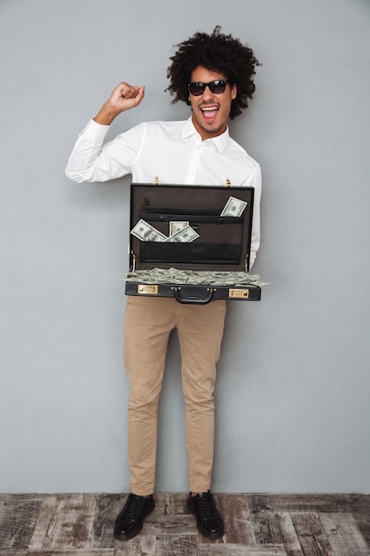 Free photo full length portrait of a cheery joyful afro american man