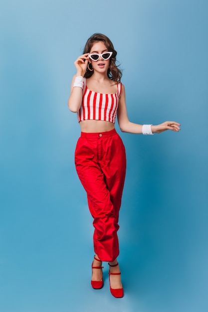 Free Photo full-length portrait of curly woman with white cloth bracelets