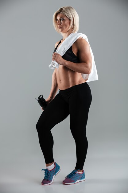 Full length portrait of a fit muscular adult sportswoman