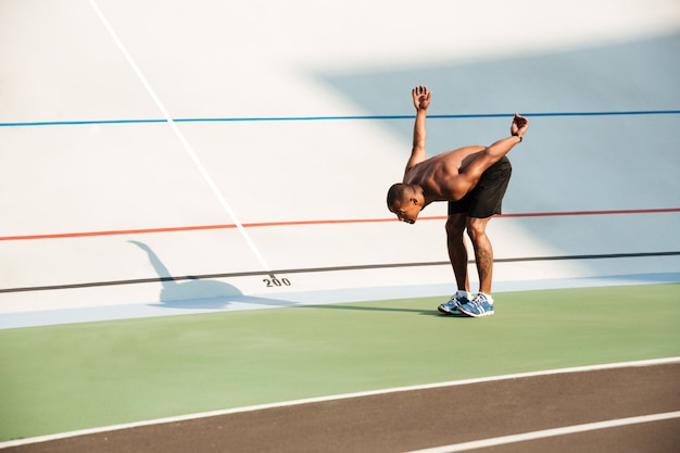 Free photo full length portrait of a half naked fit african sportsman