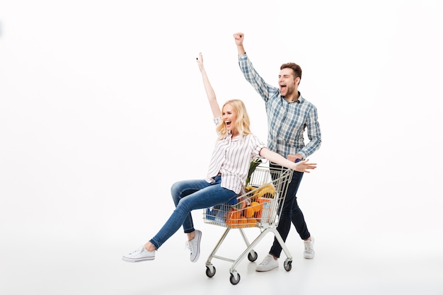 Full length portrait of a joyful couple having fun