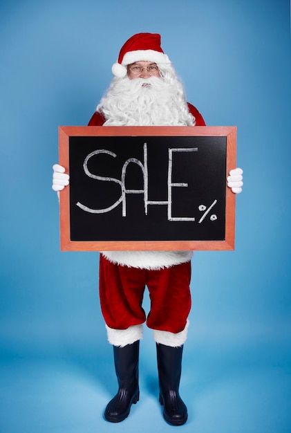 Free photo full-length portrait of santa claus holding banner