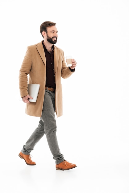 Free Photo full length portrait of a young bearded guy